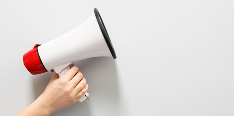 A megaphone held in one’s hand signifying how one should check if a lender advertises legally