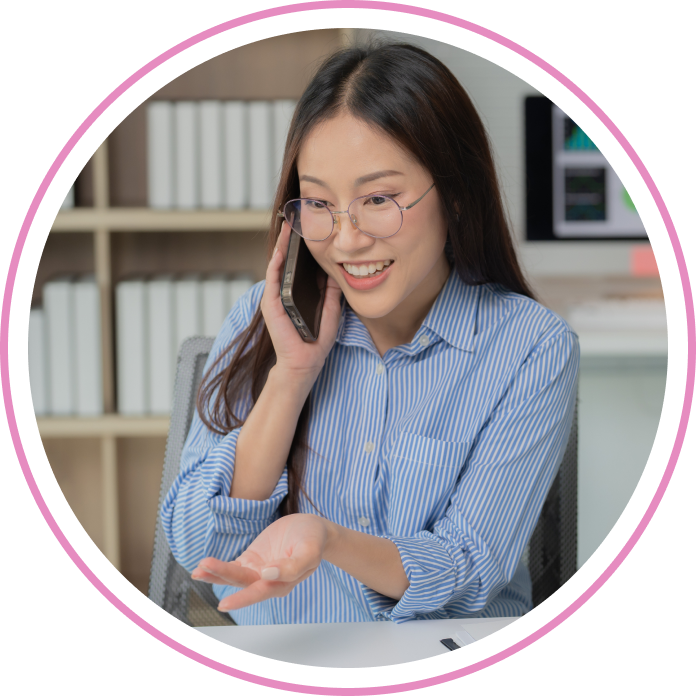 A smiling loan consultant contacts the loan applicant by phone on his approved wedding loan